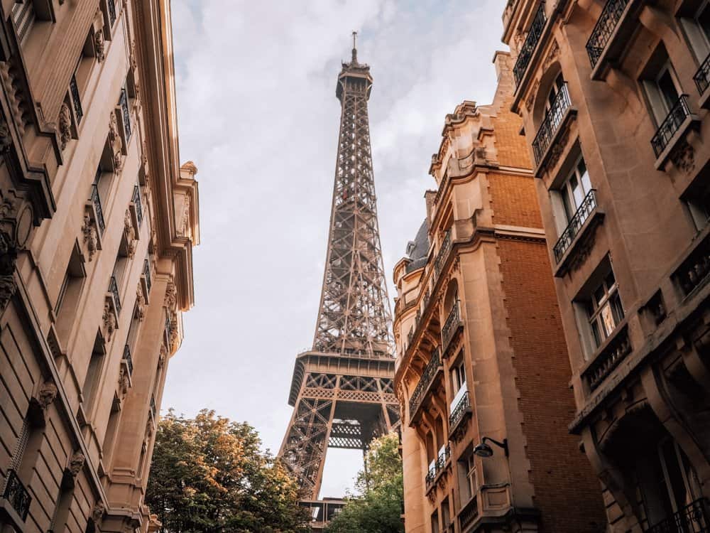 Eiffel Tower in the distance in between two buildings