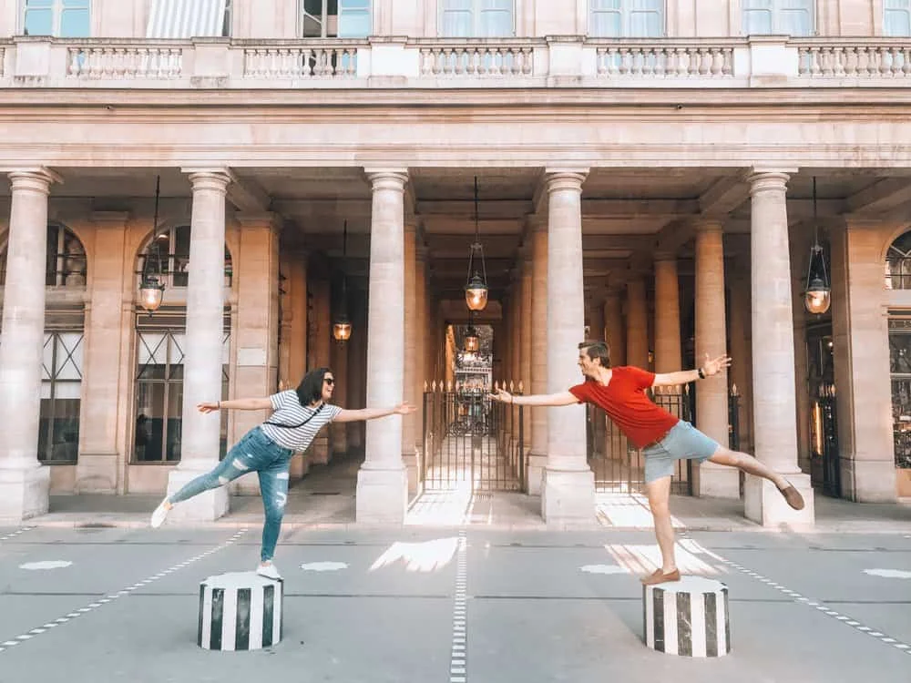 Kat and Chris balancing on the columns at Palais Royale