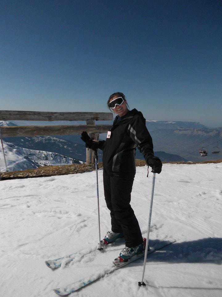 Kat in her skis at the top of a mountain