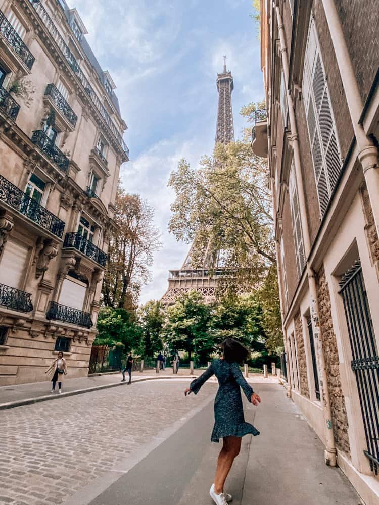 Kat posing in front of the Eiffel Tower on Rue de l'universite