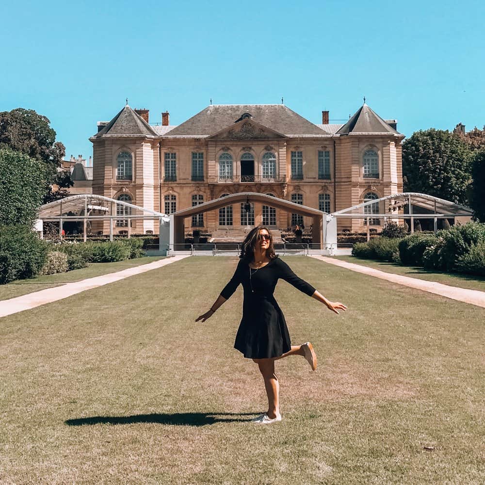 Kat twirling in a black dress in front of the Rodin Museum