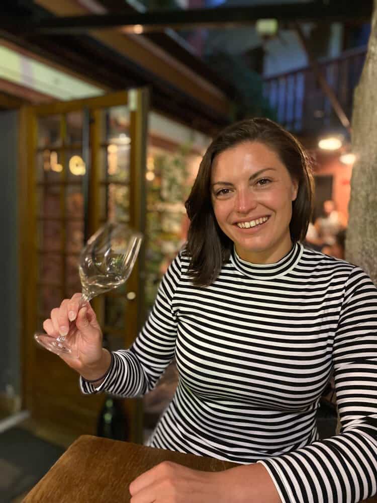 Kat with a glass of white wine in Annecy - One Day in Annecy