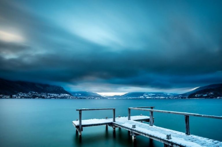 Lake Annecy in the winter with snow on a dock