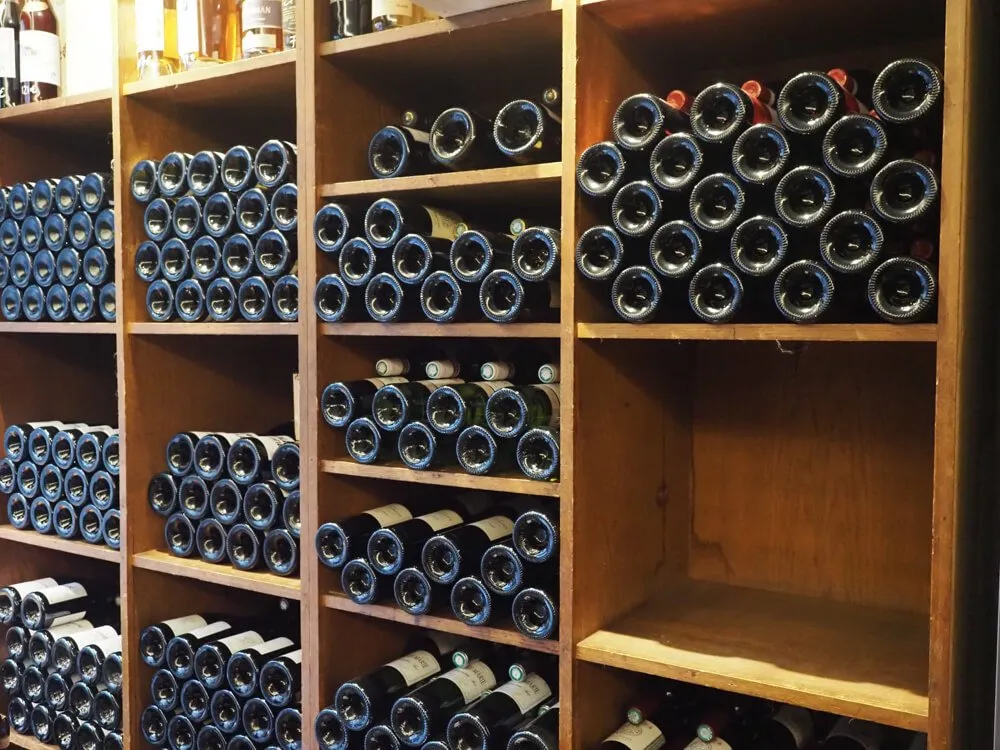 Les Juveniles Wine Bar with wine stacked on shelves