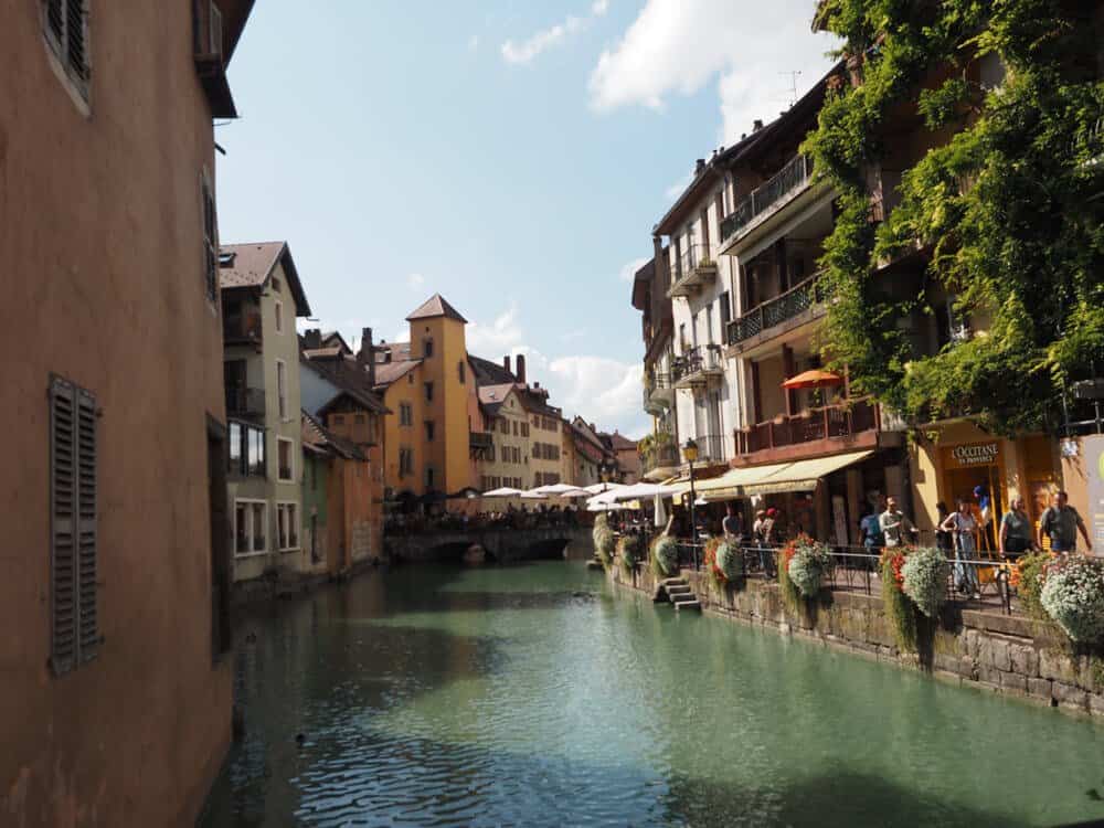 One Day in Annecy Itinerary - Canal with yellow building in the background