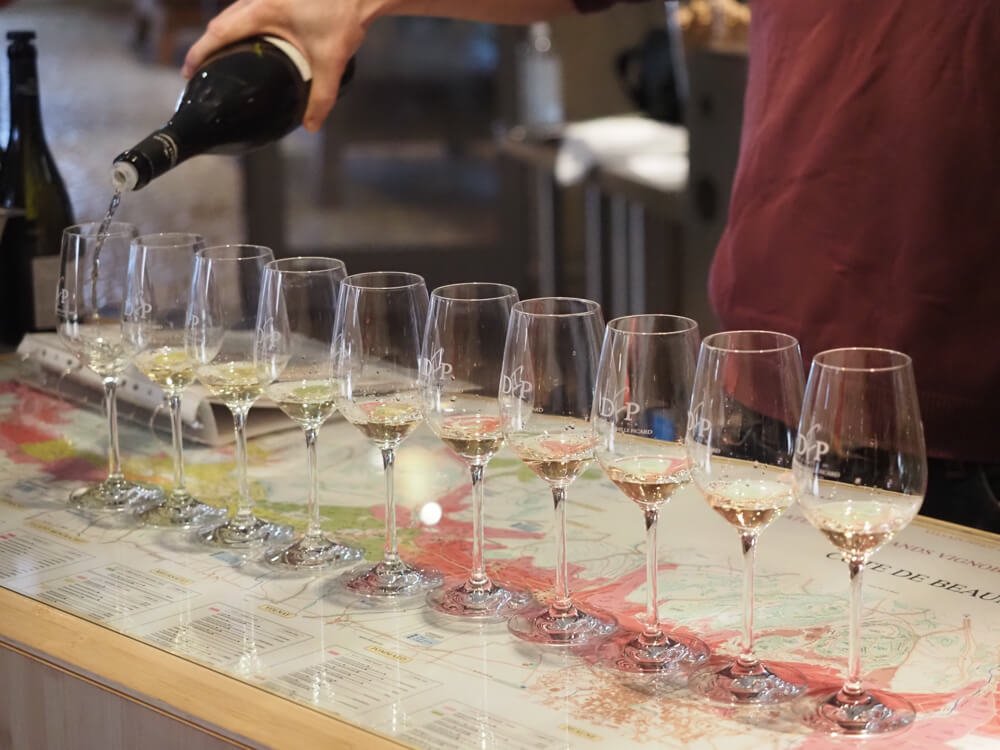 Person pouring wine for a tasting in Burgundy