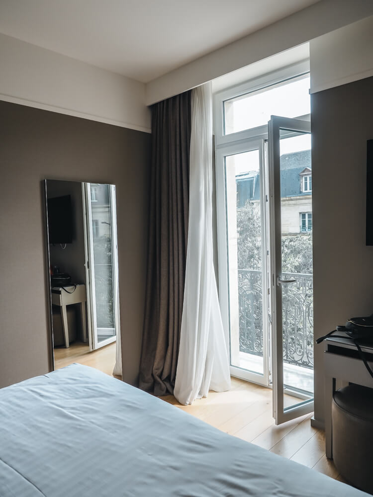 Room at our hotel in Dijon with balcony entrance