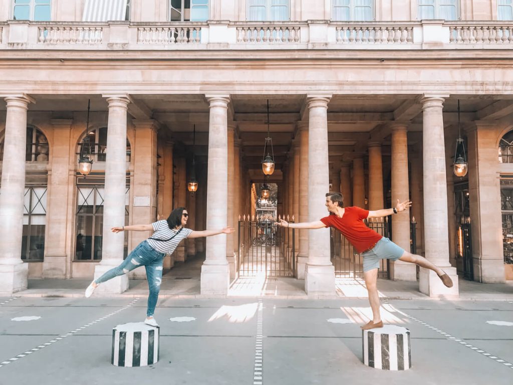 Kat and Chris balancing on the columns near Palais Royale