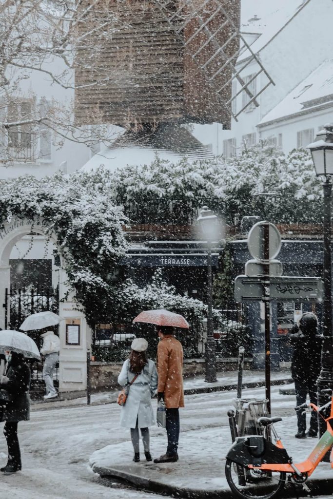 Couple on a snowy street in Paris