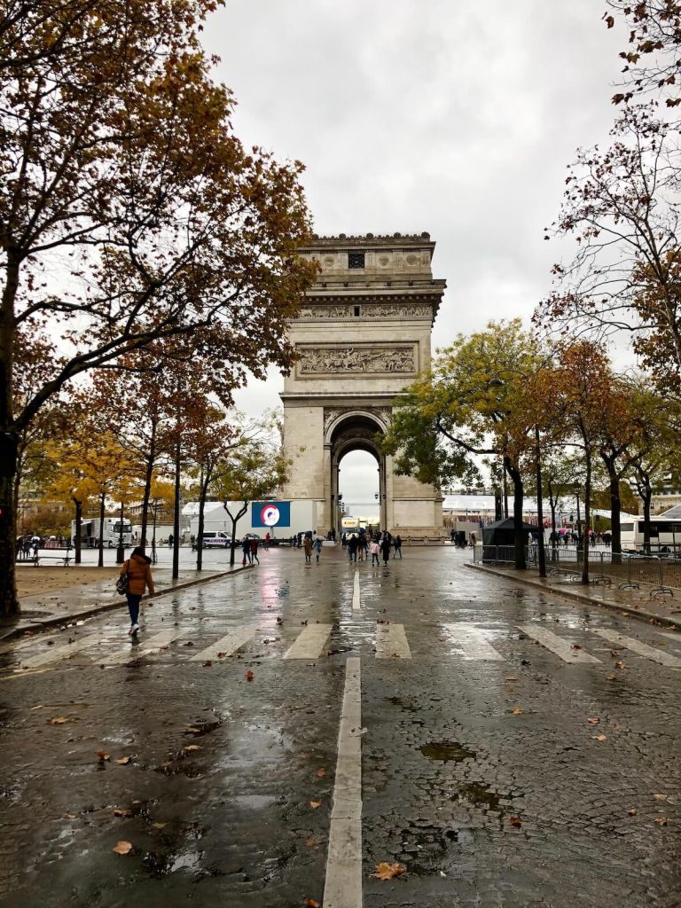 Autumn in Paris - rainy street with arch at the end