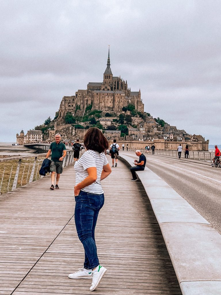 Kat twirling in front of Mt St Michel
