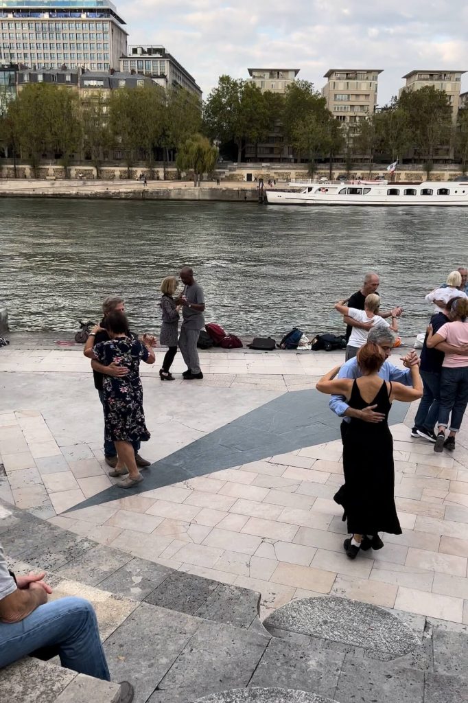 People dancing along the Seine