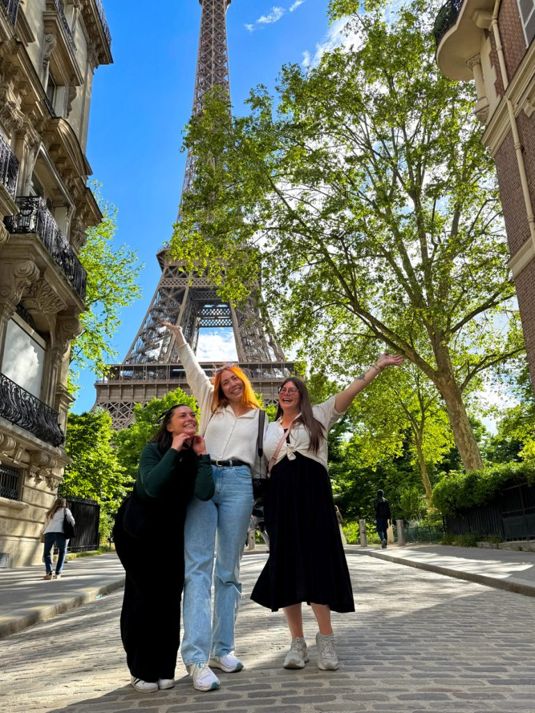 Kat, Megan, and Amanda in front of the Eiffel Tower on Rue de l'Universite