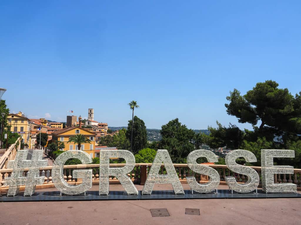 Grasse sign with view in the background