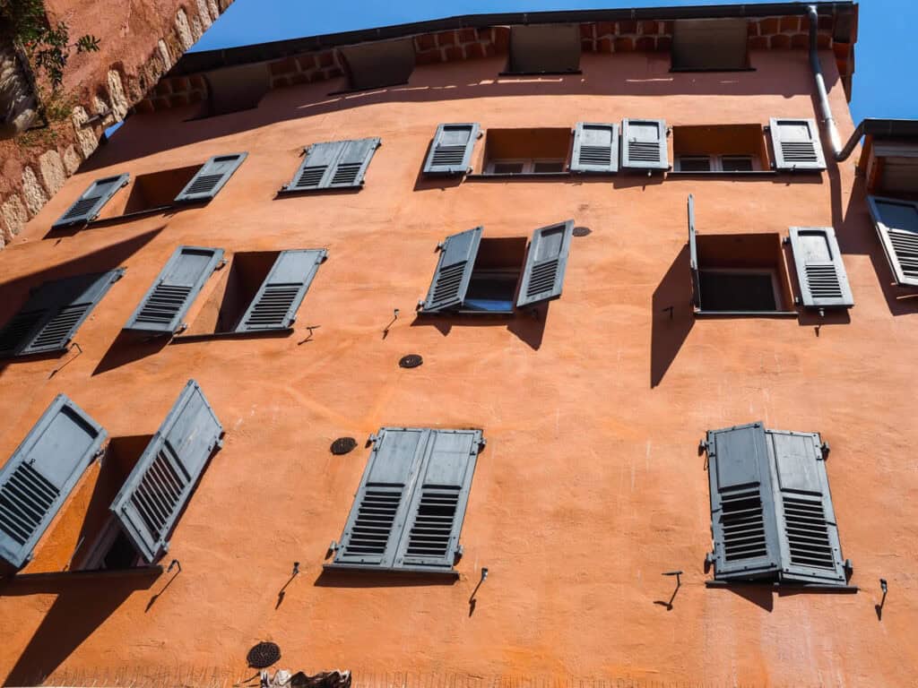 Orange building in Grasse with blue shutters