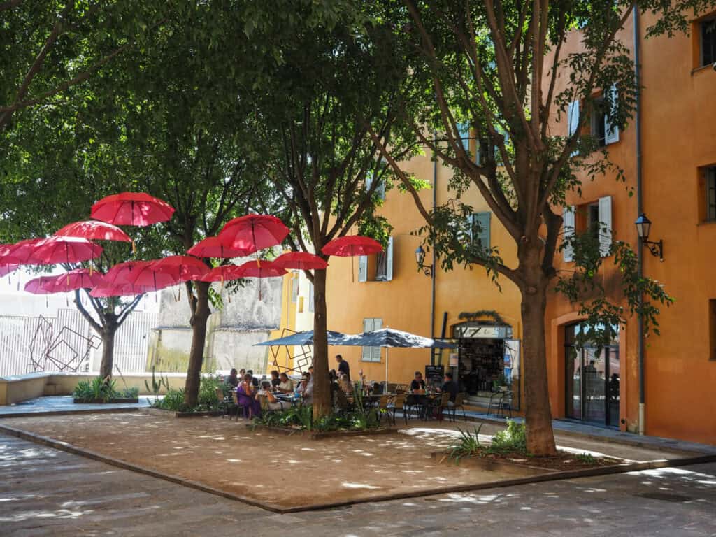 Pink umbrella-covered street in Grasse