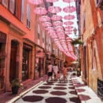 Street with shops and pink umbrellas