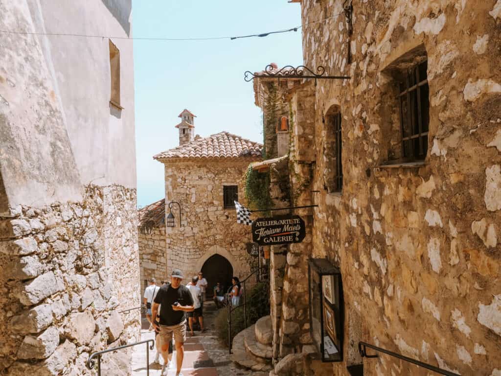 A man walking down a narrow street in a town