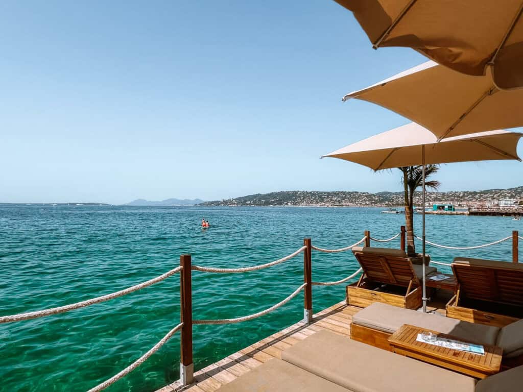 Dock with umbrellas at Yolo Beach Club in Juan-les-Pins