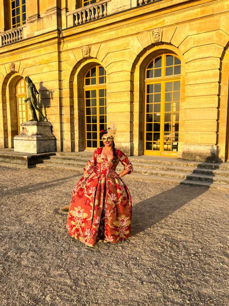 Kat wearing her dress and mask at Versailles for the Grand Masked Ball 2