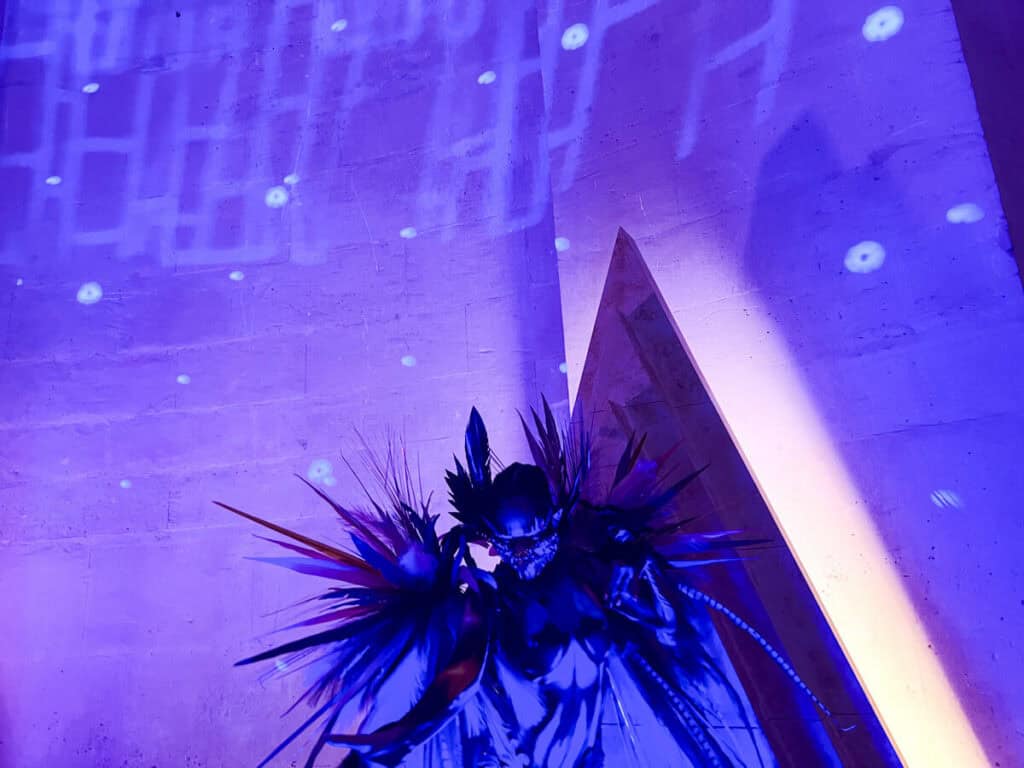 Performer posing at the entrance to the Grand Masked Ball of Versailles