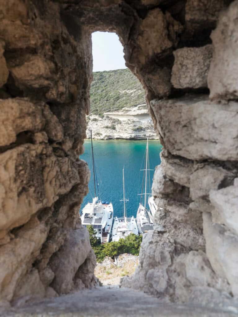 View of the Bonifacio harbor from a slit in a rock wall
