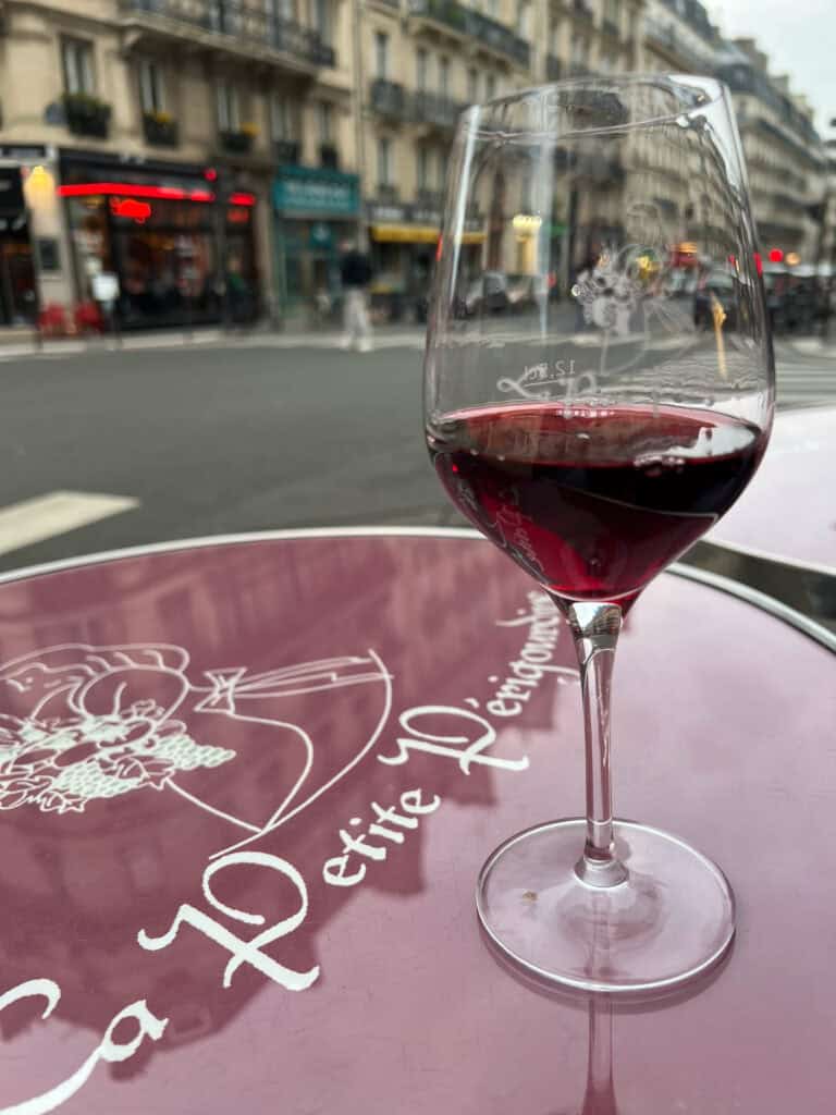 La Petite Perigourdine exteriour table with a glass of red wine