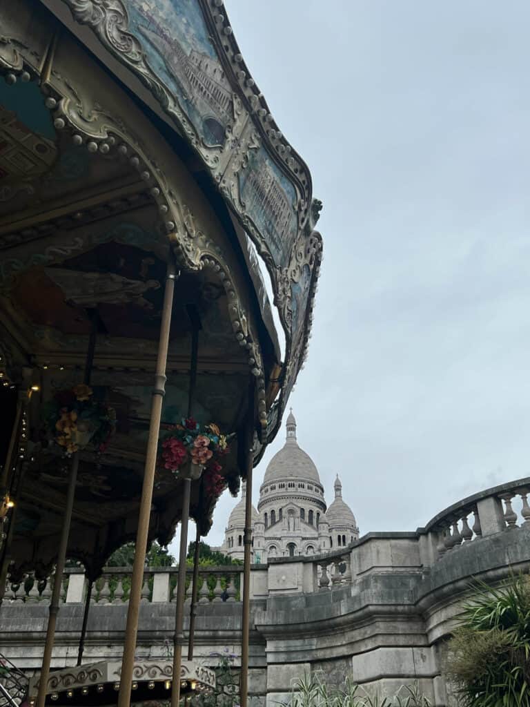 Carousel and Sacre Couer in the background in Montmartre