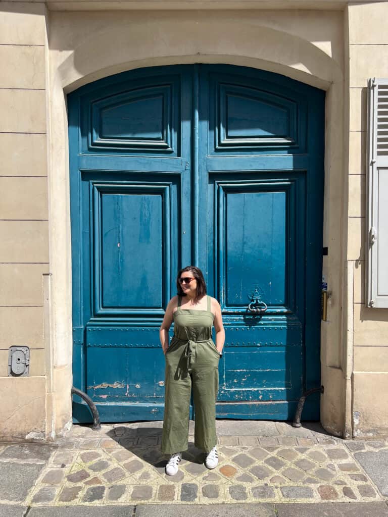 Kat in front of a blue door